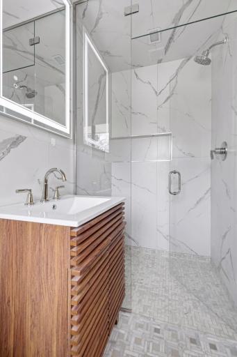 Private 3/4 primary bathroom with heated floors and curbless entry into your steam shower with chroma, aroma, and music therapy.