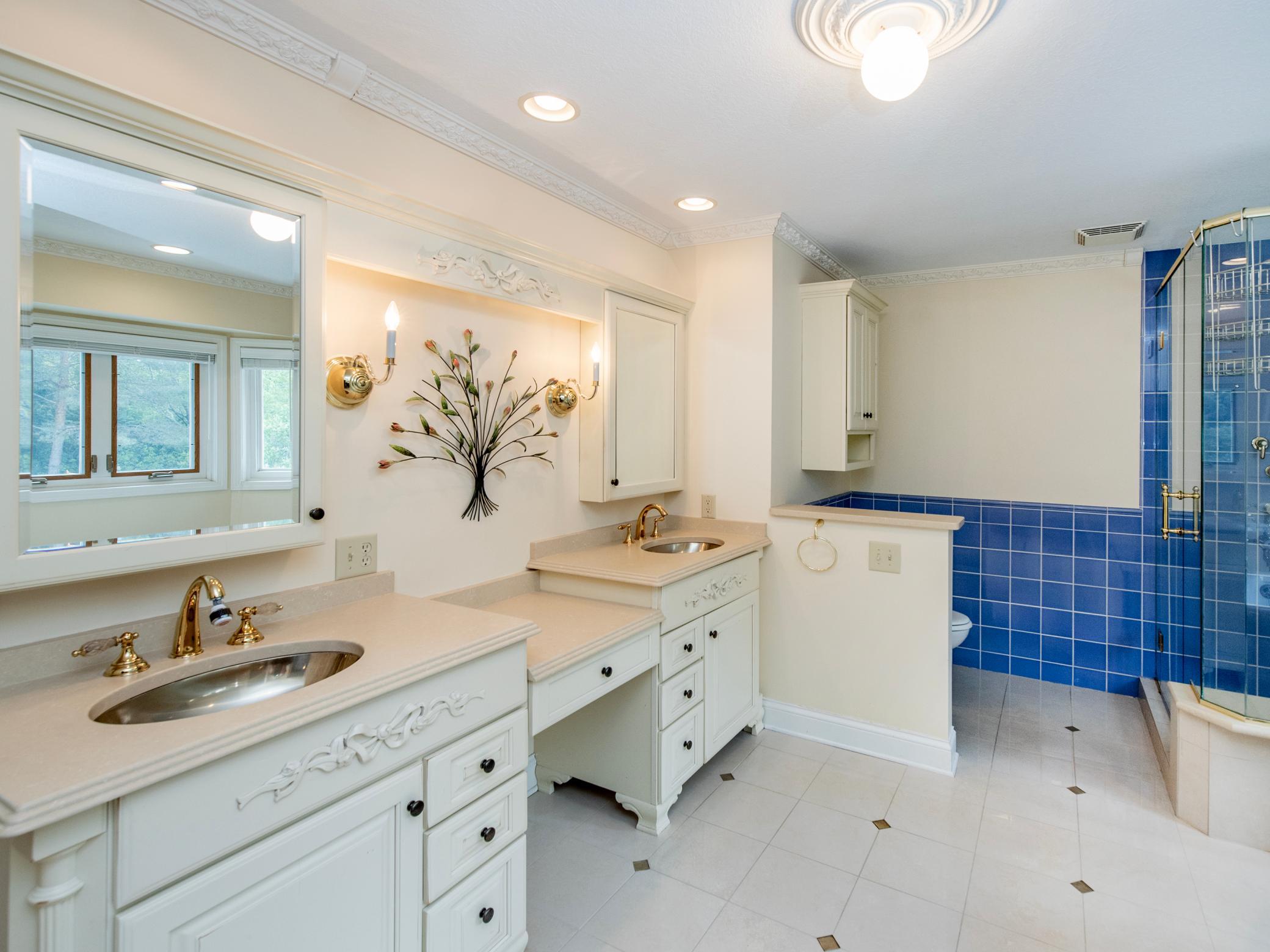 Primary full bath with double sinks and vanity space.