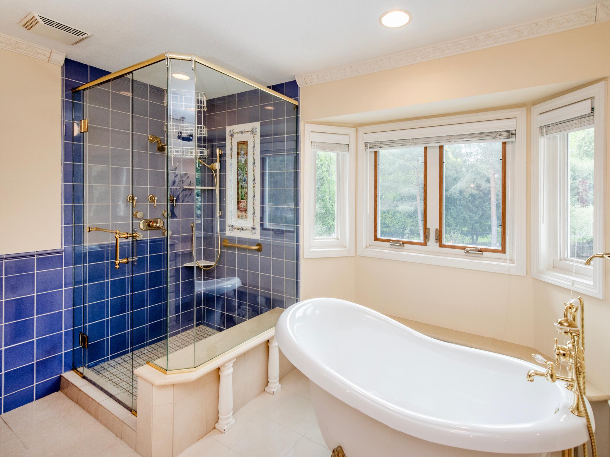 Tiled shower and claw foot tub.