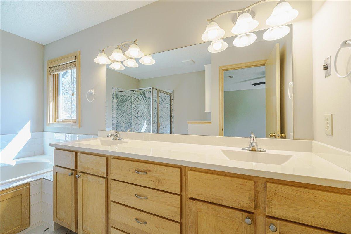 Primary dual vanity w/ marble countertop and integrated sinks