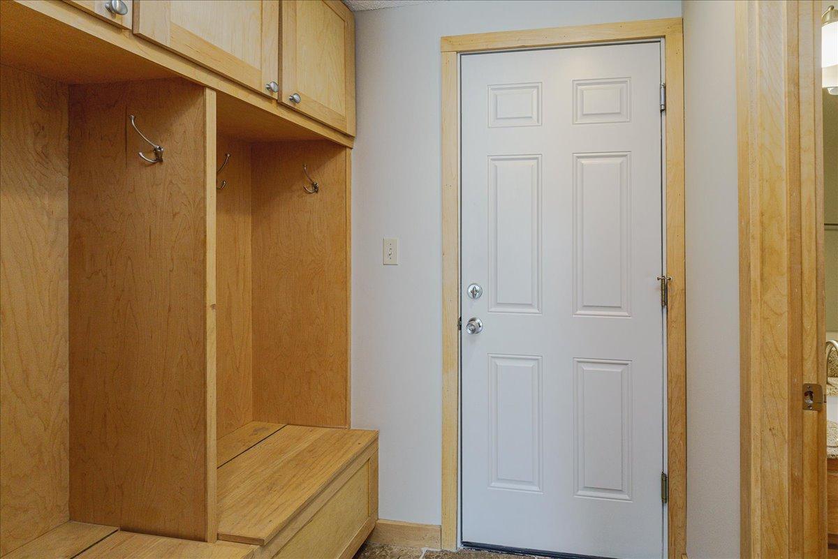 Mud room w/ locker system and travertine tile floors