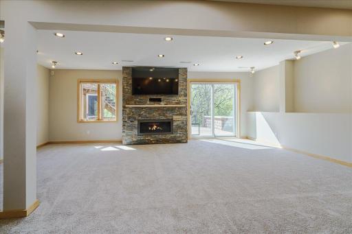 Walk-out lower level is designed for entertaining w/ a large dry bar island, abundant of natural light and a stunning linear gas fireplace w/ floor to ceiling stacked slate stone surround.