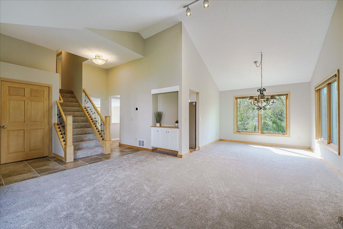 Vaulted ceilings, rich maple woodwork, fresh paint throughout, and new carpet create a warm and inviting feel across the home. Abundance of natural light and scenic private views.
