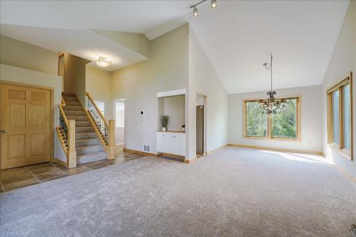 Vaulted ceilings, rich maple woodwork, fresh paint throughout, and new carpet create a warm and inviting feel across the home. Abundance of natural light and scenic private views.