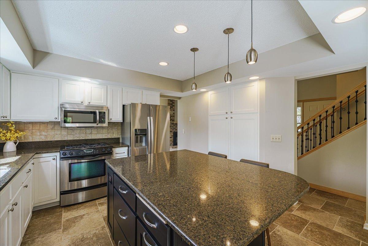 Large center island offers additional storage including wine rack, dual garbage drawer and vertical spice drawer.