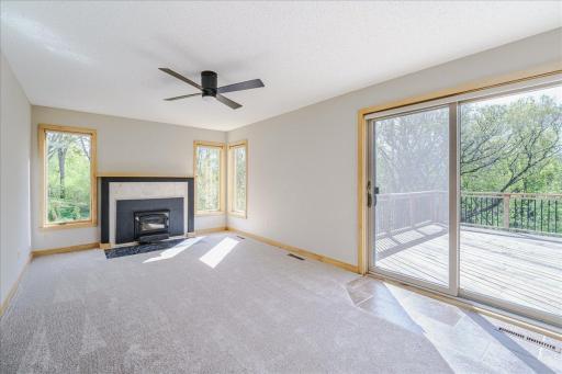 Living room walks out to deck and patio and features woodburning stove w/ tile surround.