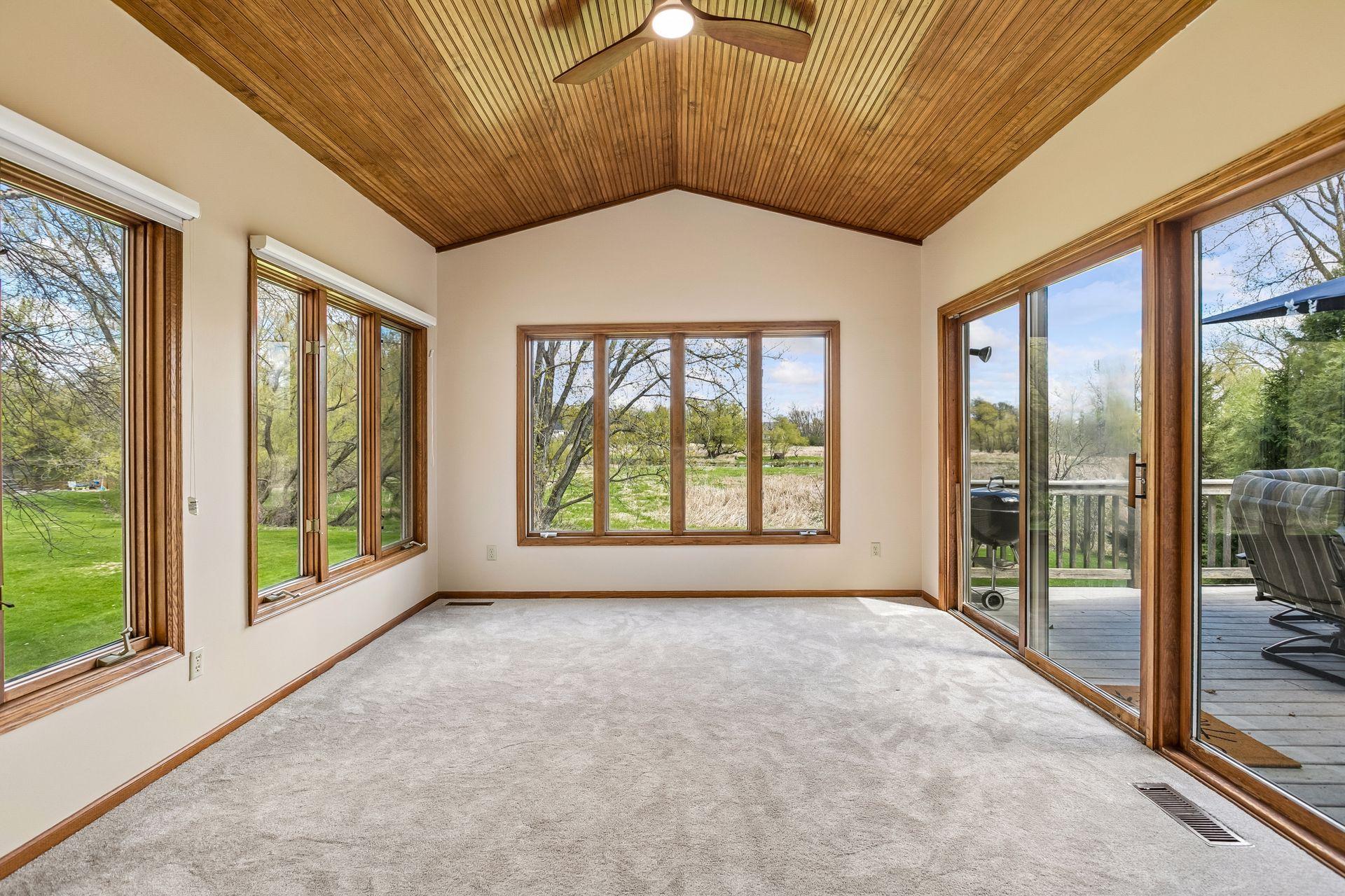 Sunroom overlooks the large open space behind the home