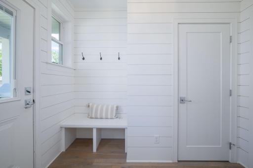 Drop zone perfection. A built-in bench with wall hooks and a bright clean layout make this mudroom the hard-working entryway every busy household needs.
