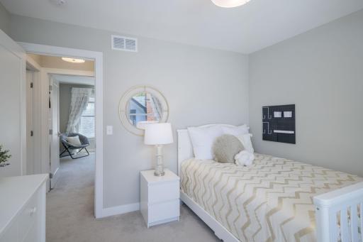 Generously sized and filled with soft natural light, this upper-level bedroom offers the perfect canvas for guests, kids, or a peaceful home office.