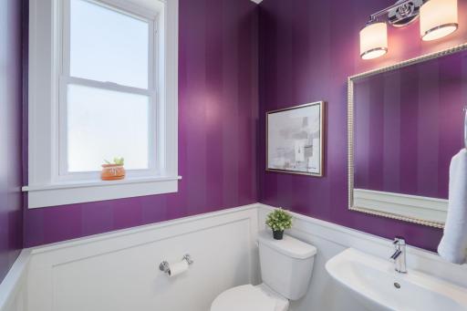 Bold, beautiful, and utterly intentional, the powder rooms' dramatic purple walls and classic white millwork prove that great design lives in every corner of this home.