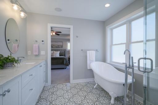 Silk Unwind Reset. The free-standing tub, mosaic tile floors, and soft natural light from the privacy windows make this bath a daily escape you'll look forward to.