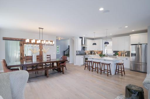 Two of the home's best spaces in one frame. The generous dining room and a gourmet kitchen flow together effortlessly, making this main level as impressive to live in as it is to look at.