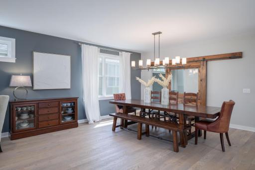 Set the table and invite everyone. This dining space commands the attention with its soaring chandelier, rich finishes, and a layout that flows effortlessly into the main living areas.