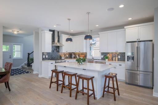 Room to breathe, room to create. The kitchen's generous footprint, wrap-around cabinetry, and central island make it as functional for busy mornings as it is for dinner parties.