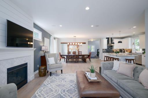 One sweeping glance tells the whole story. Living room, dining, and kitchen all flow together in a bright open layout that makes this home feel both grand and genuinely livable.