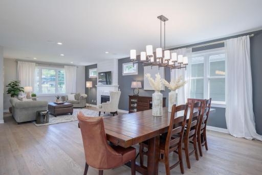 This is truly the heart of the home, where dining, living, and entertaining converge under soaring ceilings in a stunning multi-light chandelier that commands the room.