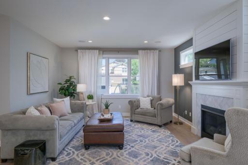A lovely second living room angle, cozy, curated, and filled with natural light. The living room's neutral palette, linen drapes, and thoughtful furniture arrangement create a space that instantly puts you at ease.