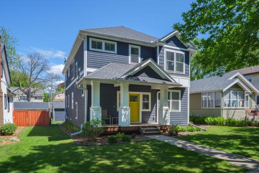 Craftsman Charm meets newer construction. The bold Navy exterior, welcoming front porch, and sunny yellow door make an unforgettable first impression in the heart of Fulton.