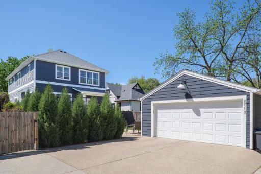 A generous attached garage, wide driveway, and mature evergreen screening add practical appeal and privacy to this already exceptional property.