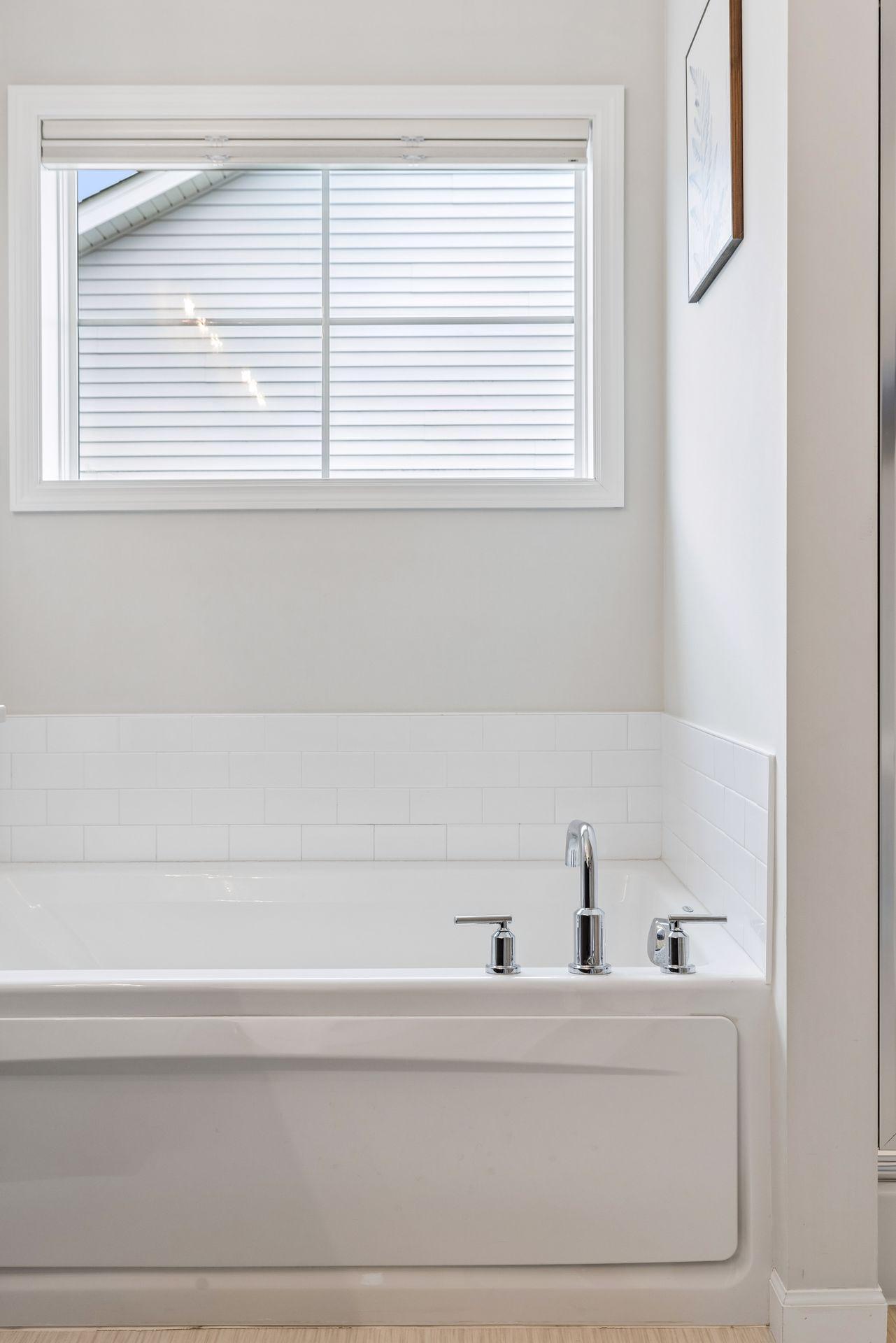 Large window brings in natural light while maintaining privacy in the bathroom space.