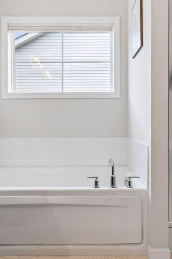 Large window brings in natural light while maintaining privacy in the bathroom space.