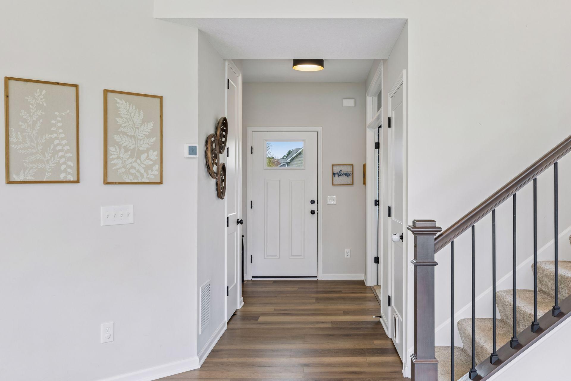 Warm LVP flooring and neutral finishes create a bright, inviting feel throughout the main level.