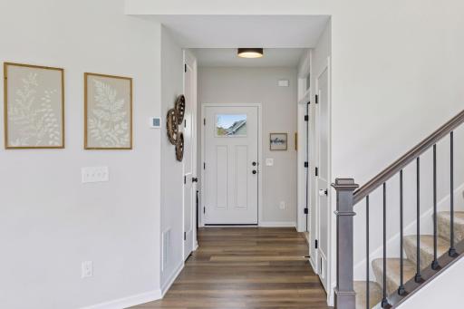 Warm LVP flooring and neutral finishes create a bright, inviting feel throughout the main level.