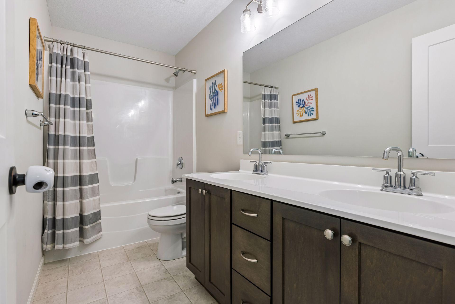 Upper level full bath conveniently located near the secondary bedrooms with oversized vanity and great storage space.