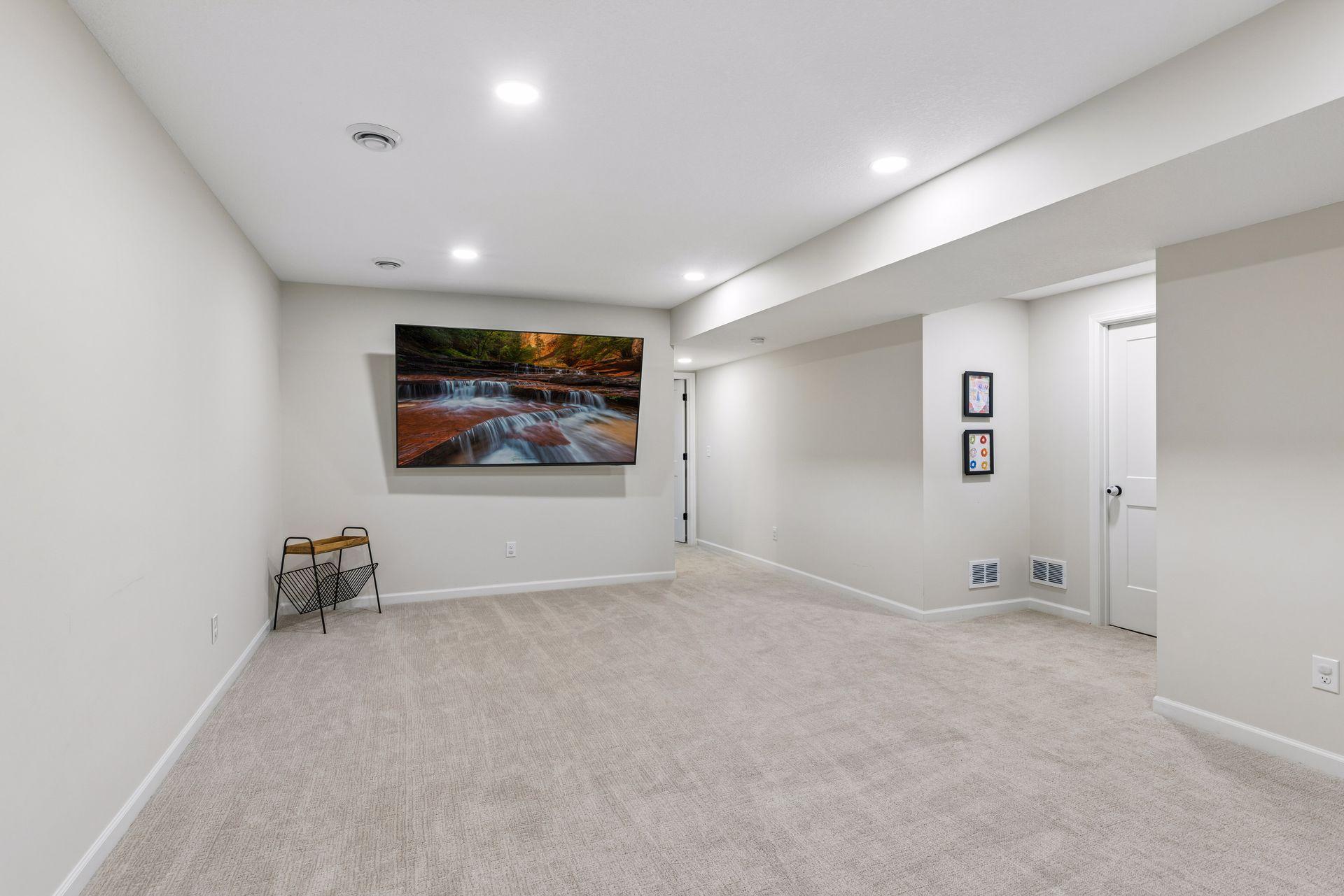 Another view of the spacious lower level family room showcasing the bright recessed lighting and flexible living space.