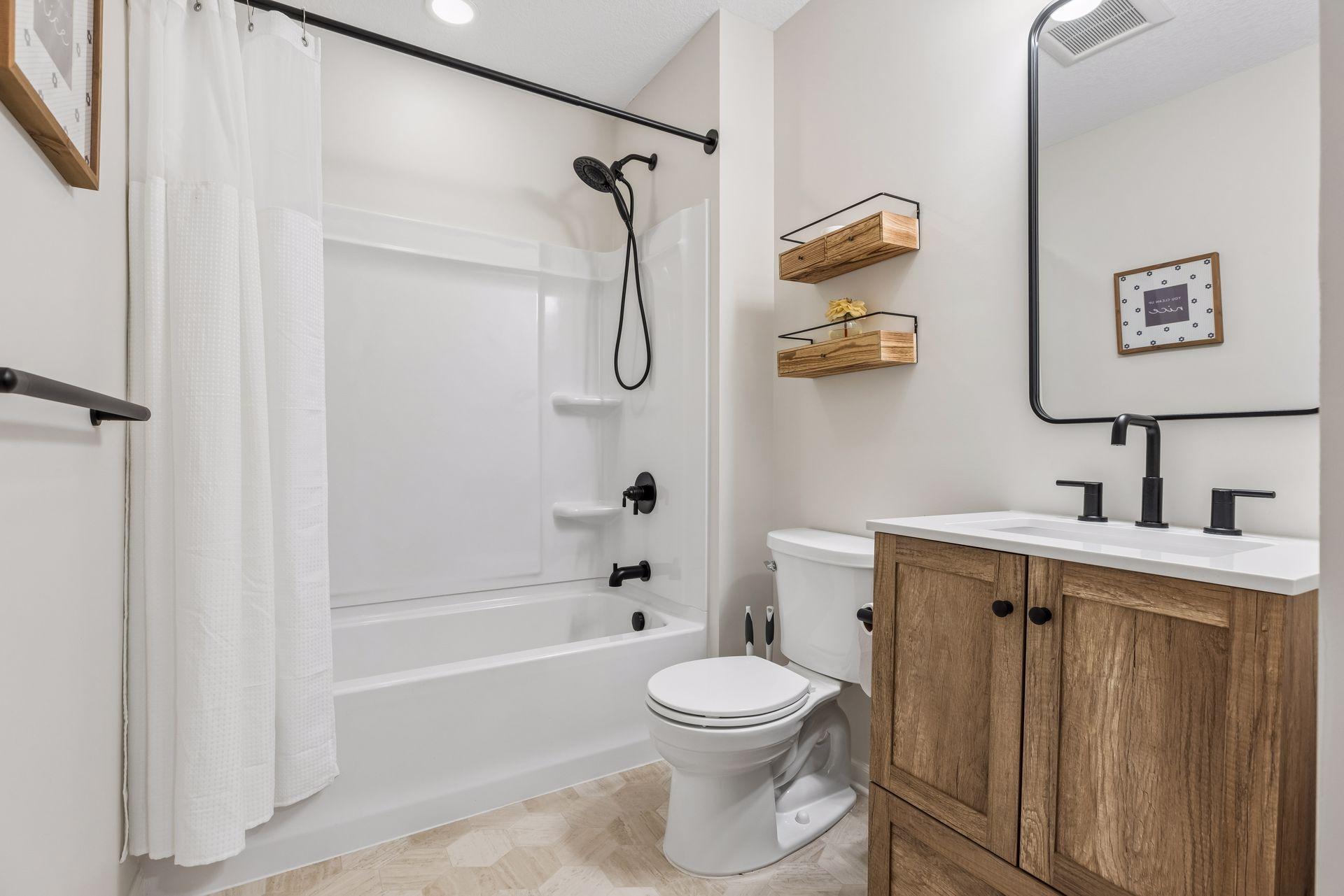 Updated lower level full bath with stylish finishes, modern fixtures, and convenient access to the lower level living spaces.