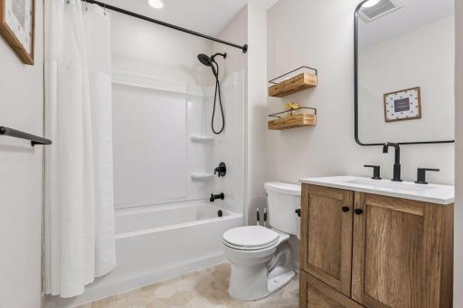 Updated lower level full bath with stylish finishes, modern fixtures, and convenient access to the lower level living spaces.