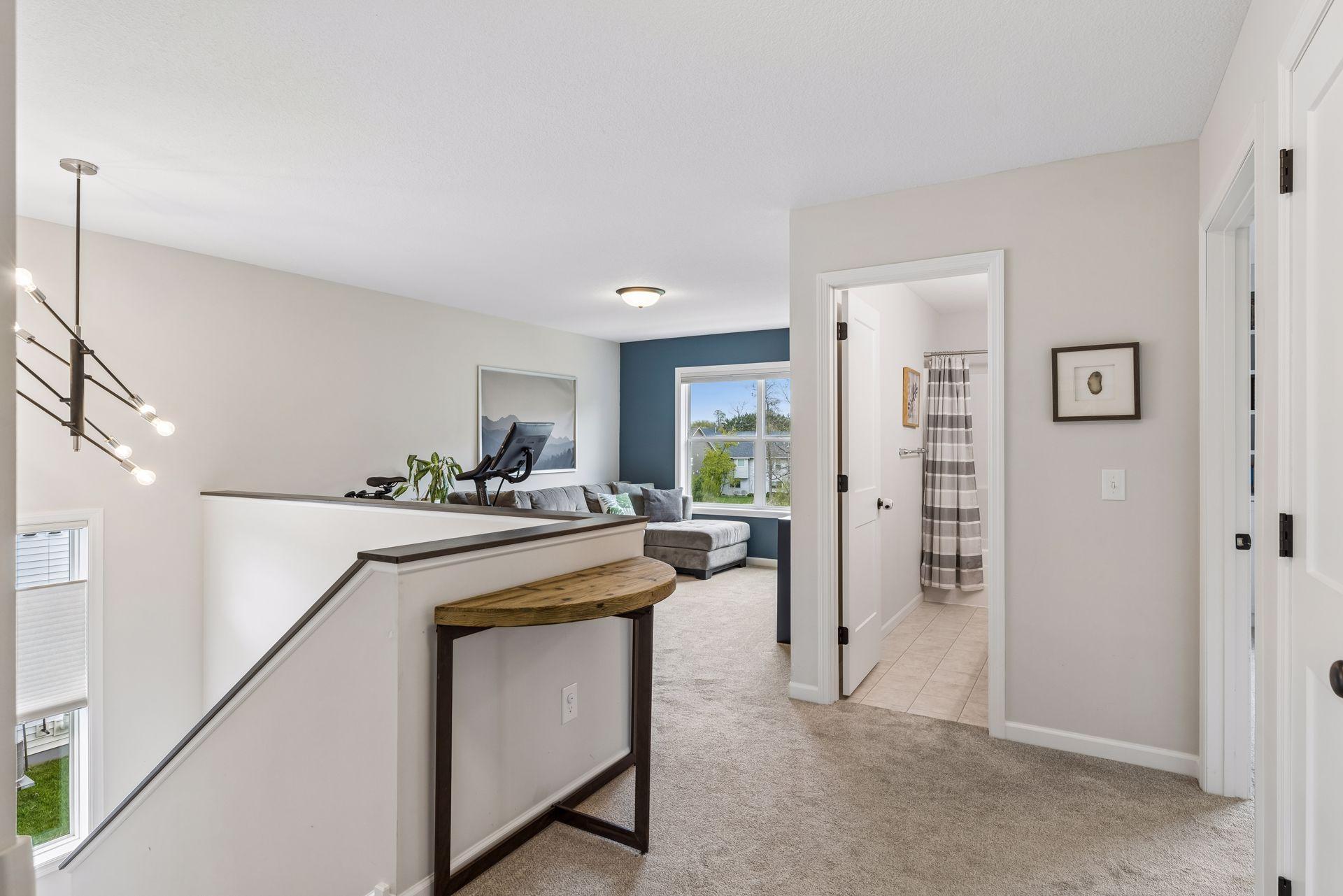 Spacious upper level landing leads to the loft, bedrooms, and upper level baths. The window in the stairwell adds in so much natural light.