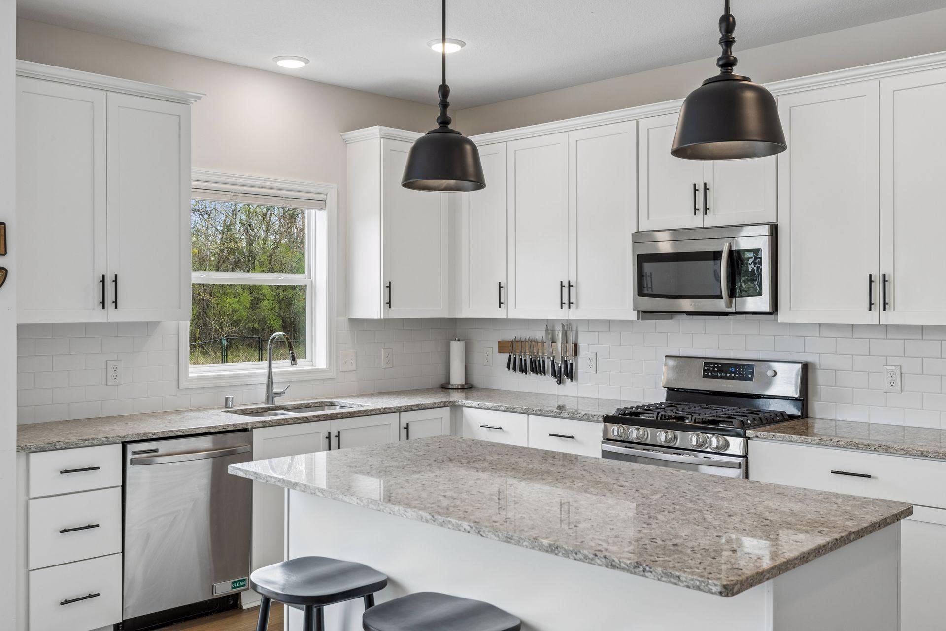 Other features include stainless steel appliances, recessed lights, and subway tile backsplash.
