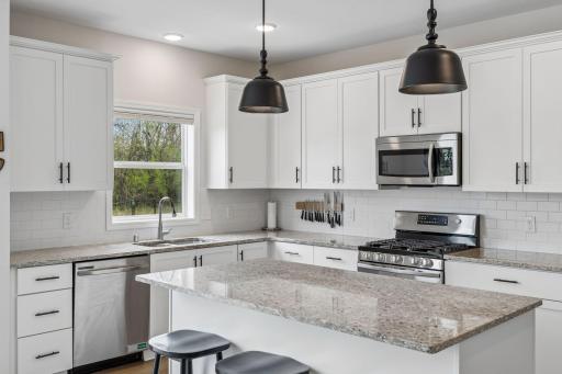 Other features include stainless steel appliances, recessed lights, and subway tile backsplash.