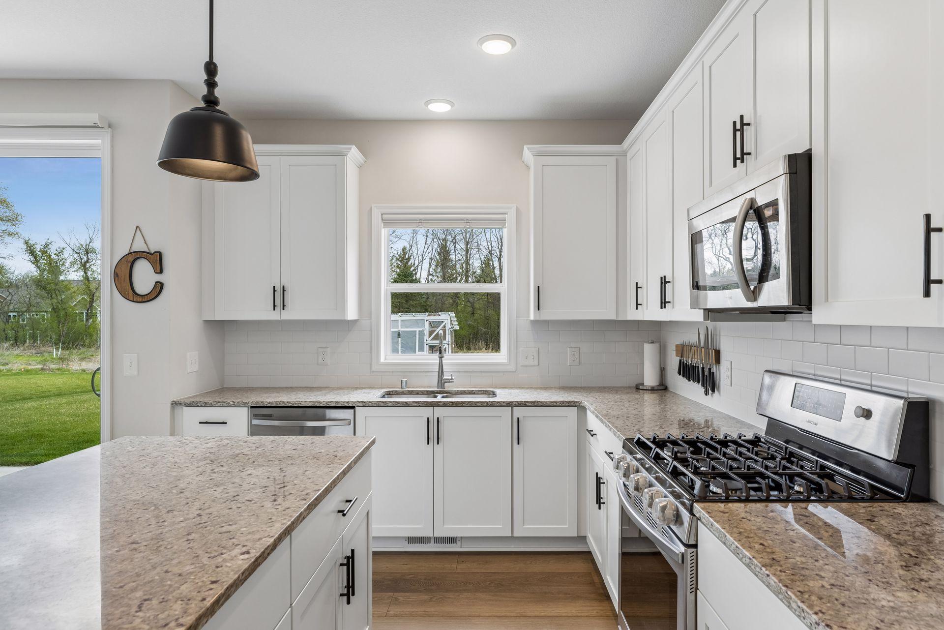 Window over the sink brings in great natural light and offers peaceful backyard views.