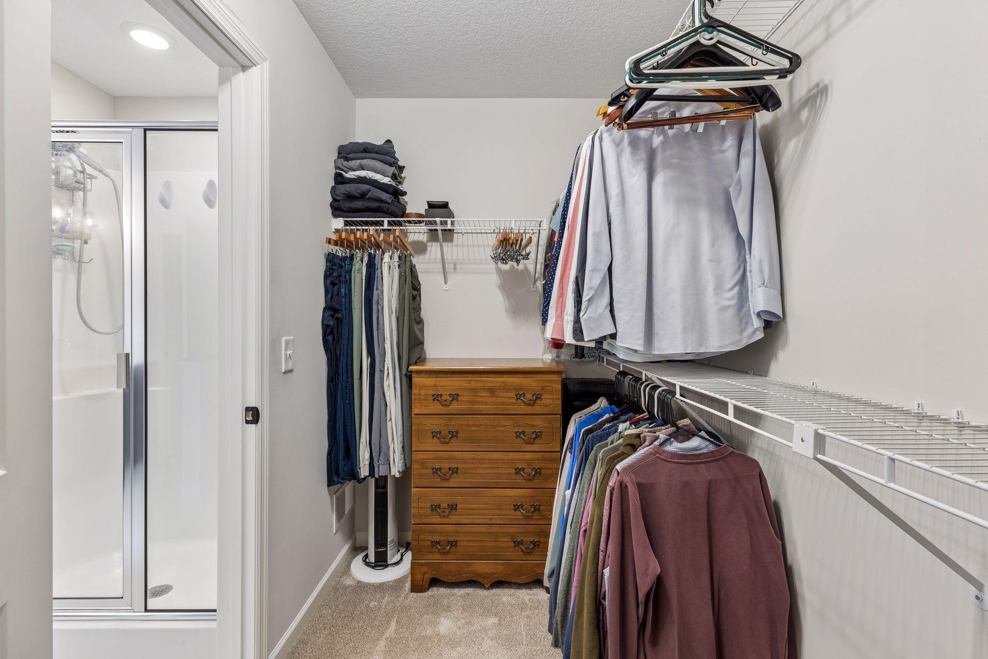 Spacious walk-in closet with plenty of hanging space and room for additional storage and organization.