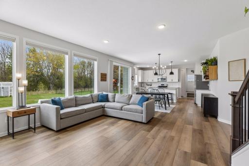 Spacious main level with oversized windows, abundant natural light, and great sightlines throughout the living, dining, and kitchen spaces.
