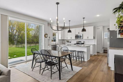 Dining space is filled with natural light and offers easy access to the patio and private backyard through the sliding glass door.