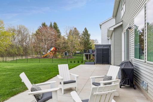 Huge concrete patio offers plenty of space for outdoor dining, entertaining, or simply enjoying the private backyard setting.