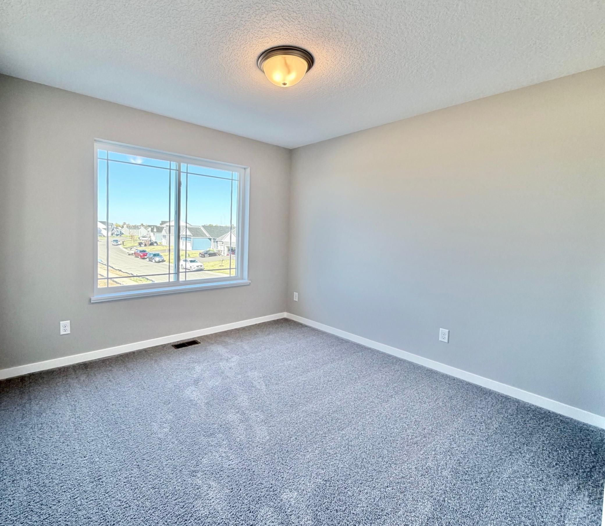 PHOTO OF A DIFFERENT HOME WITH SIMILAR PLAN. FINISHES MAY VARY. Bedroom 3.