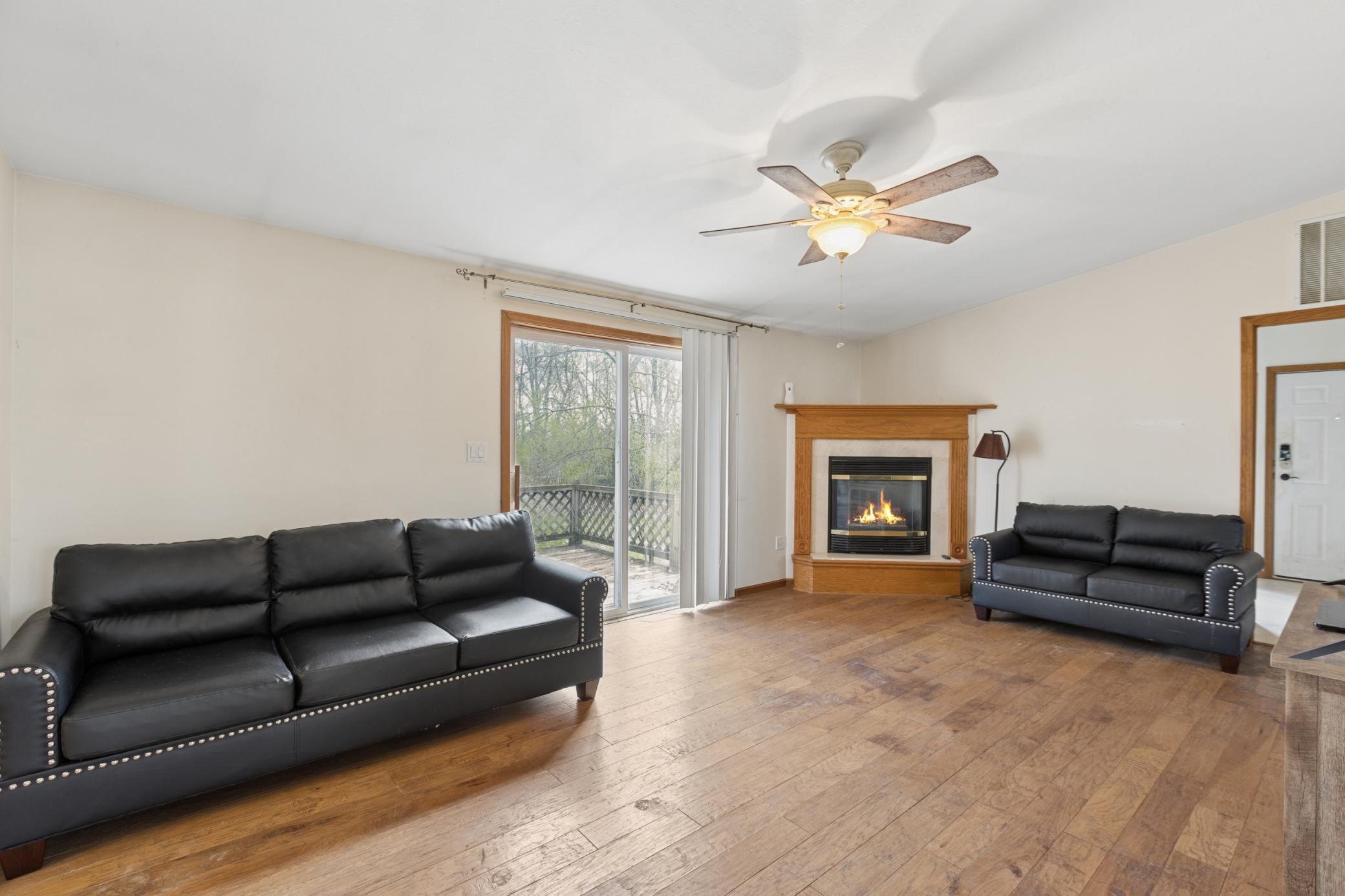 Main floor family room with gas fireplace and door to deck.