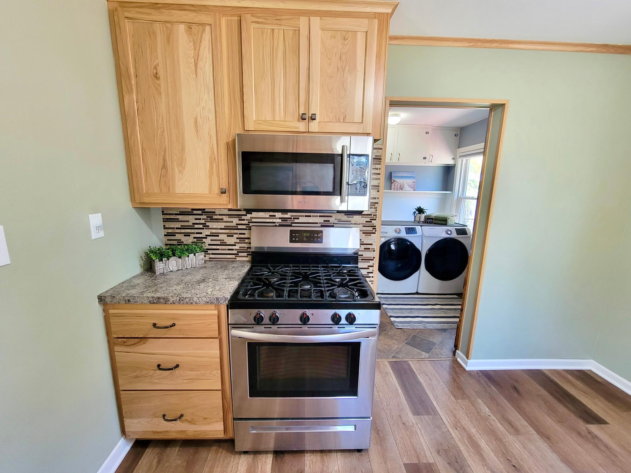 Gas stove and newer hickory drawer. See how convenient the laundry room is.