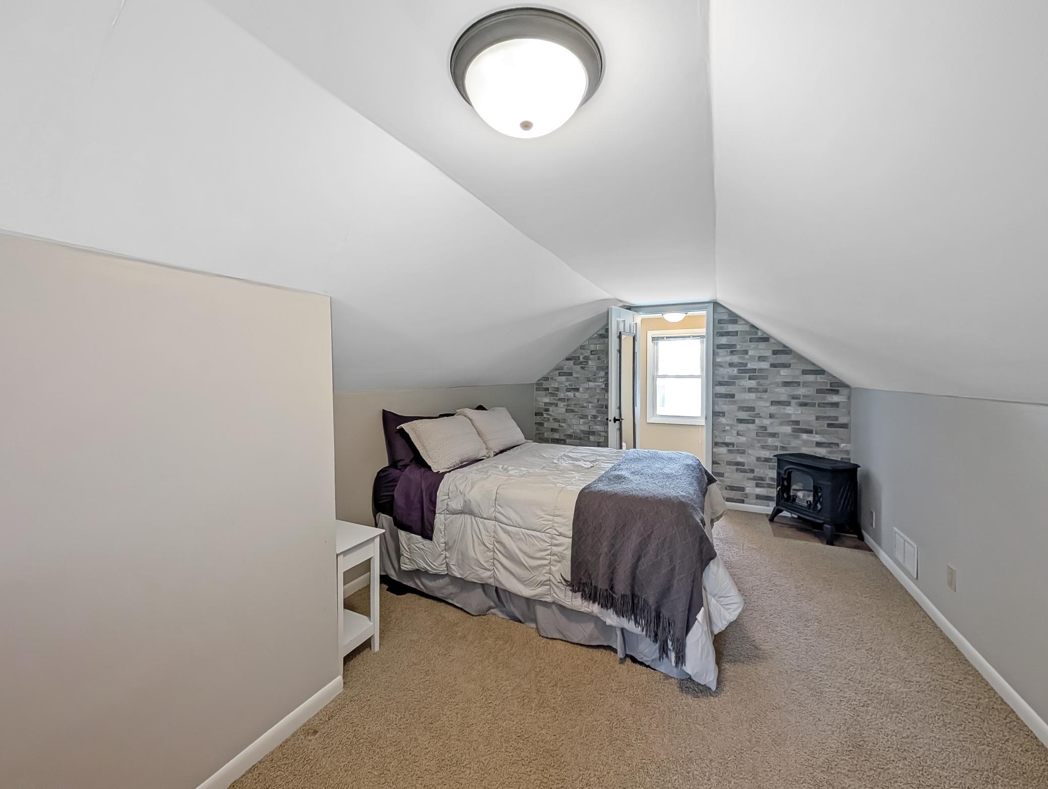 A perfect primary or guest bedroom with an accent wall for style.