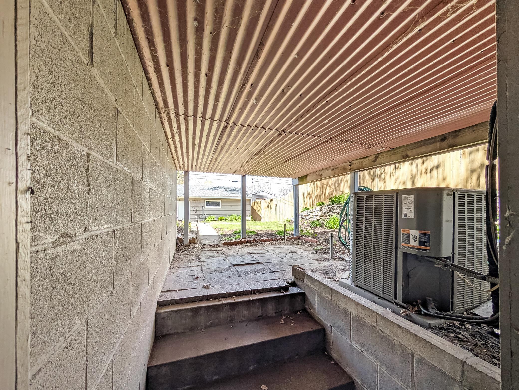 Door from basement leads outside just under the deck.