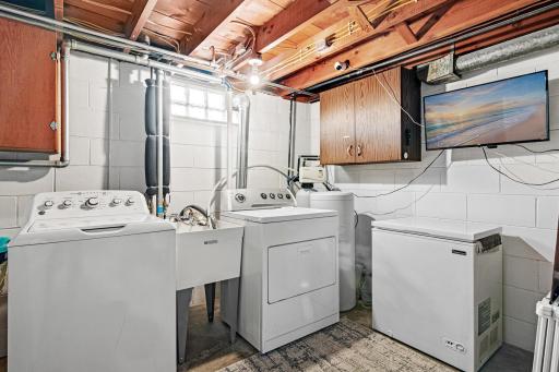 Lower level laundry room with updated appliances.