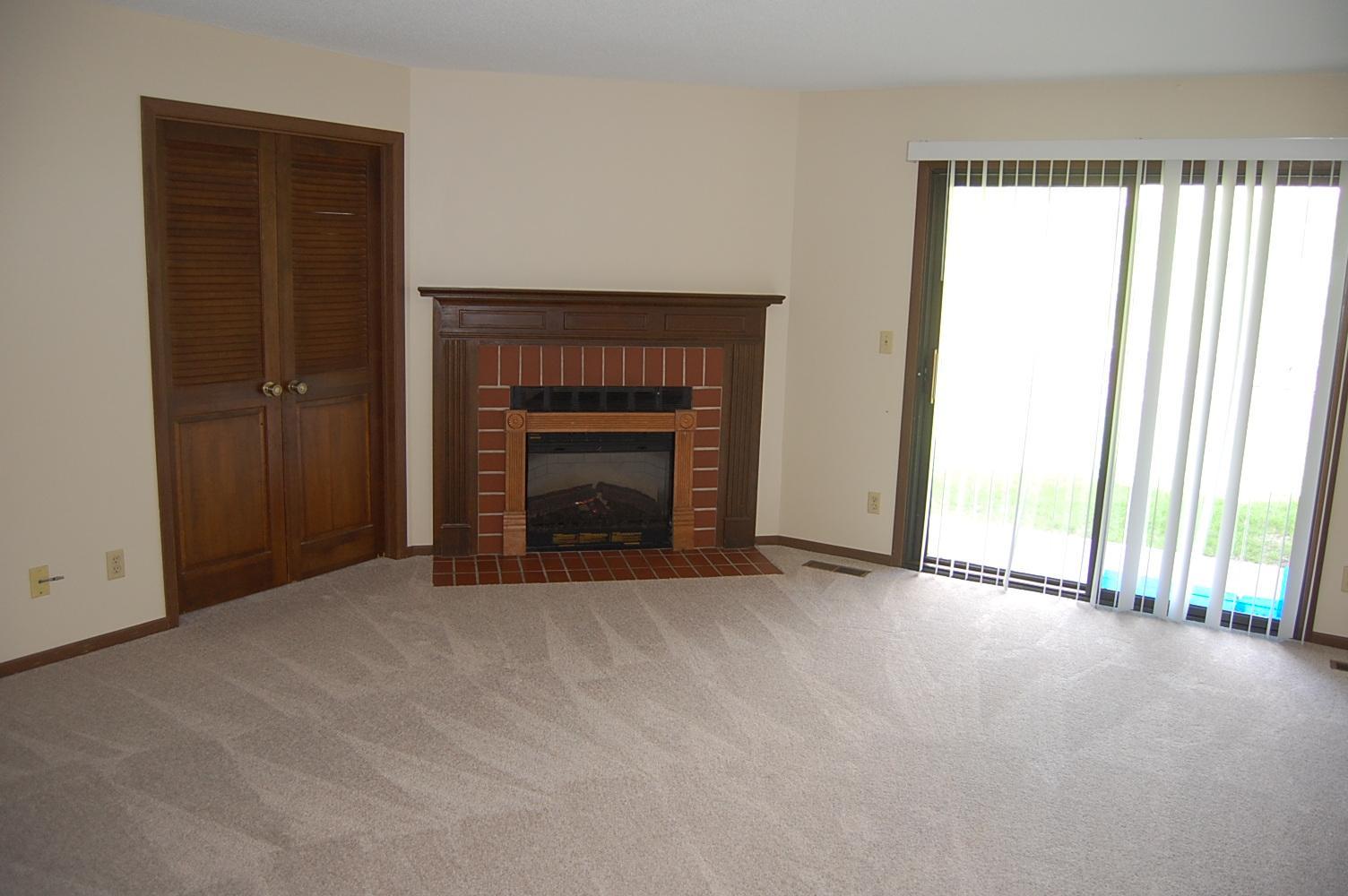 Large living room with a decorative F/P. Acess to the patio.