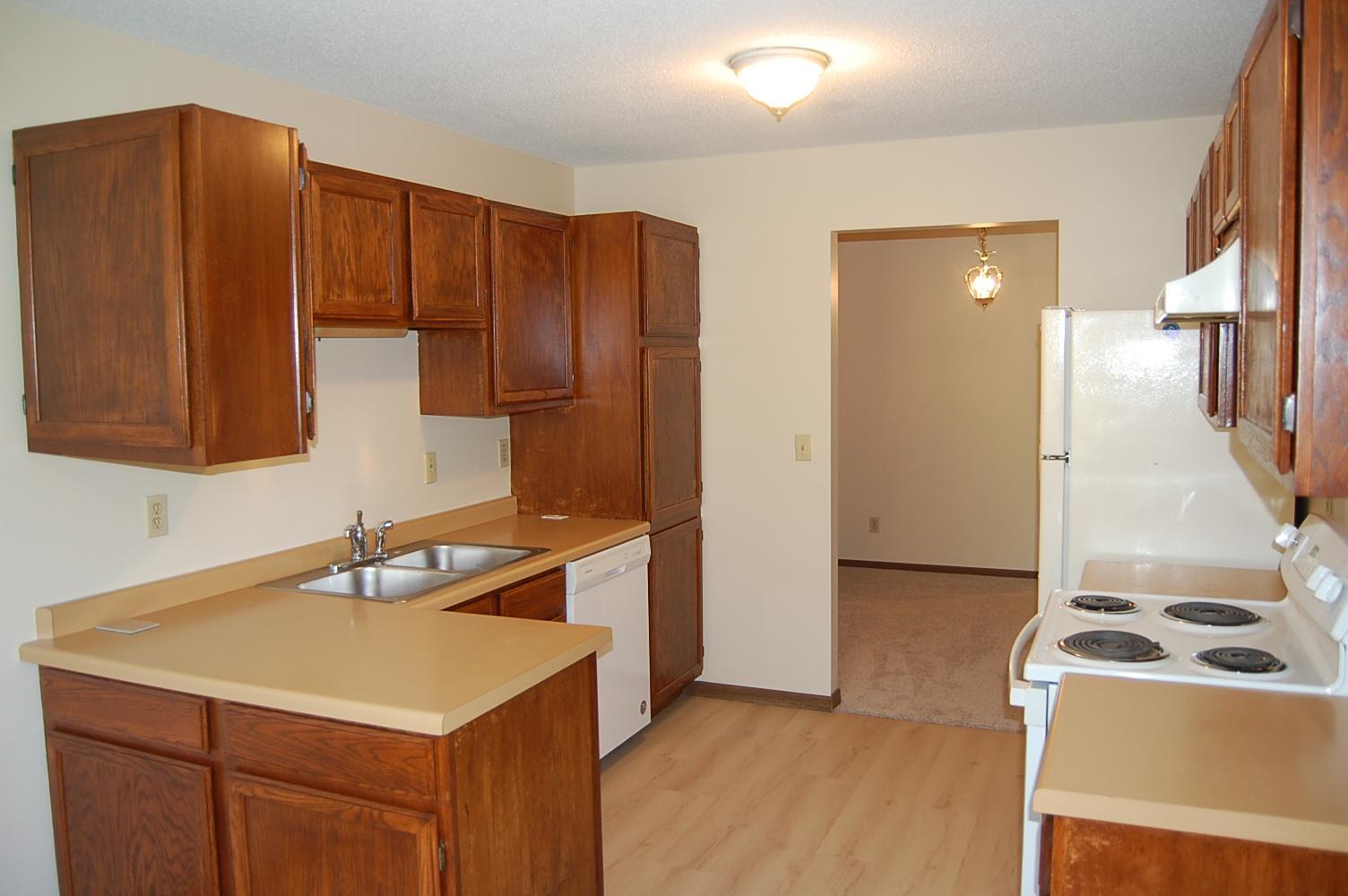 Spacious kitchen area includes the stove, refrigerator and dishwasher.