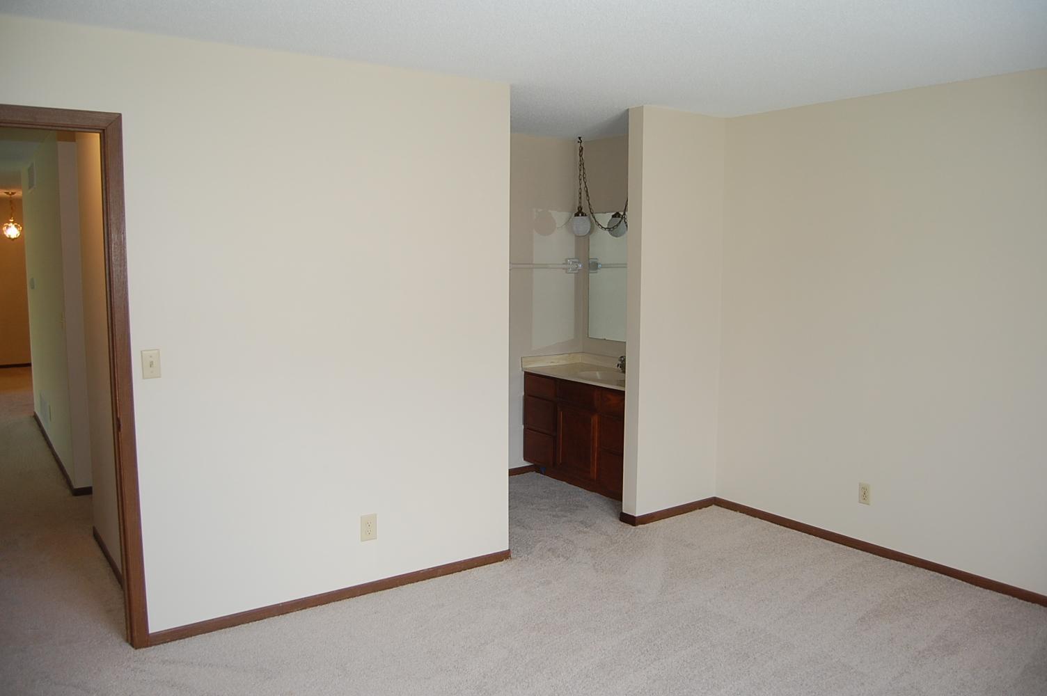 Spacious primary bedroom just painted with new carpeting. Includes a walk-in closet and a 3/4 bathroom with a new bath room floor.