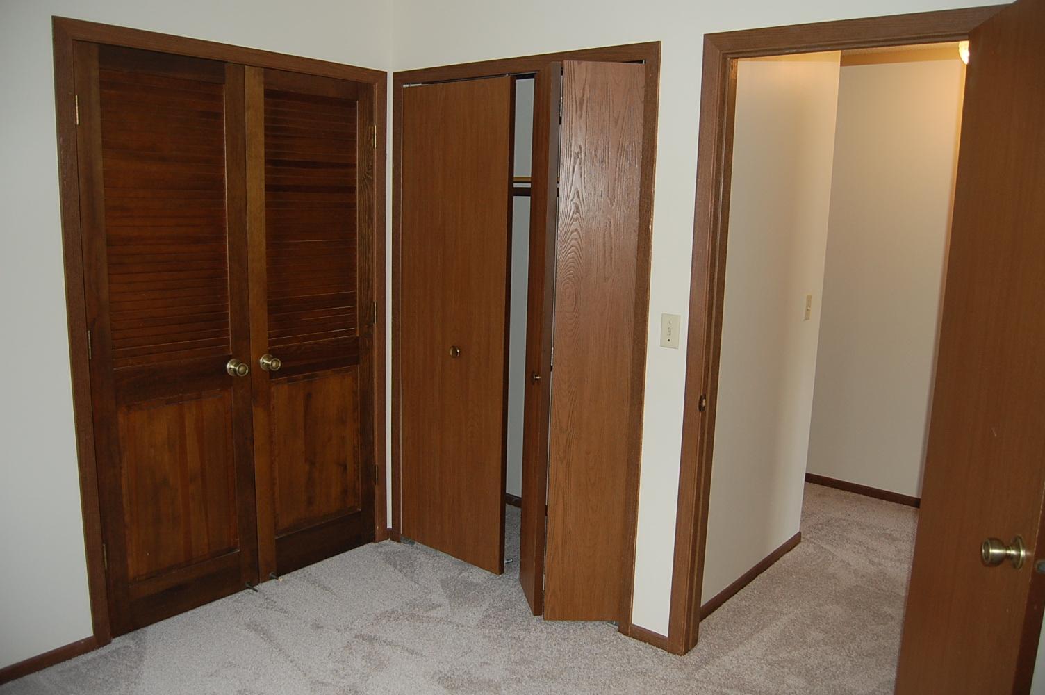 This bedroom has access to the living room.