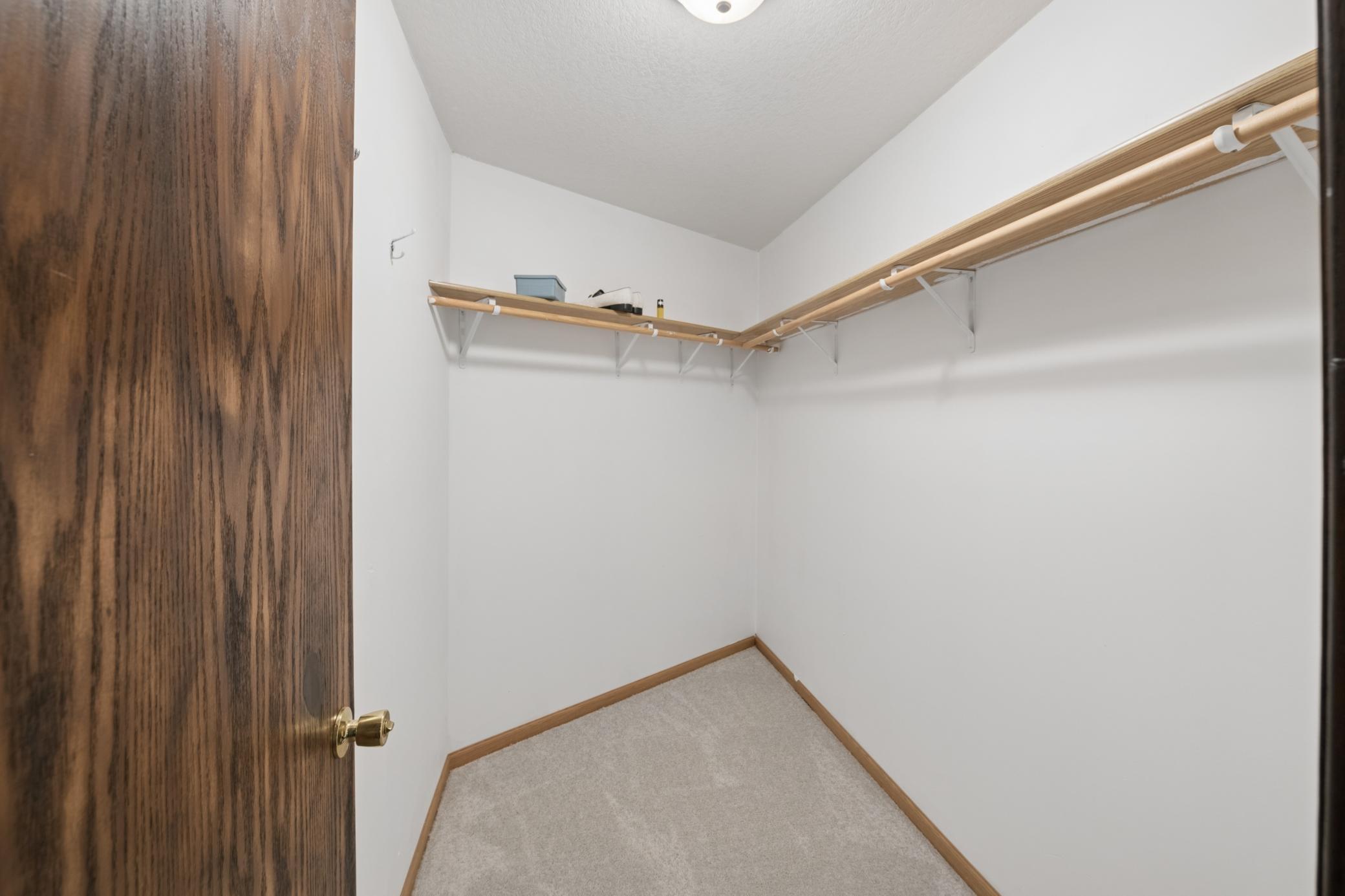 Primary bedroom walk-in closet